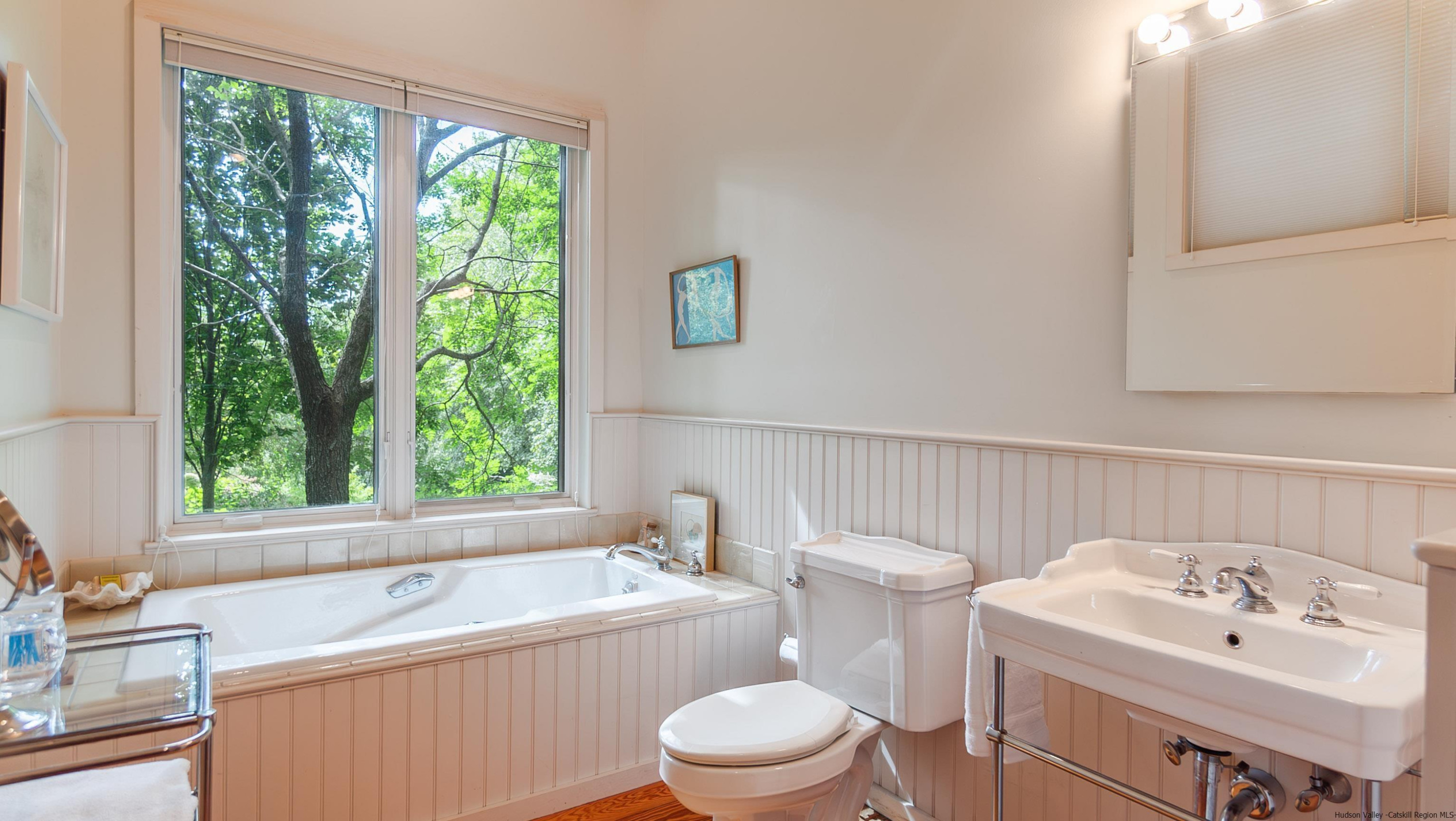 310 Jims Road Mount Tremper, NY 12457 - Photo 32 of 35 a bathroom with a sink a toilet and a window