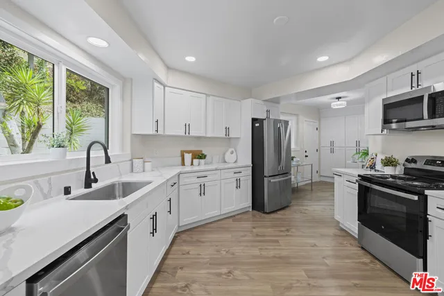 a kitchen with a sink stove and refrigerator