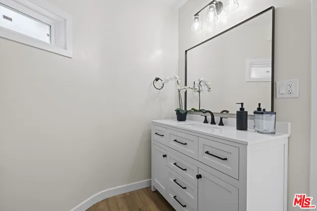 a bathroom with a sink vanity and mirror