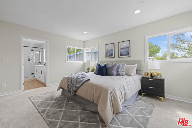 a bed room with a bed and a painting on the wall