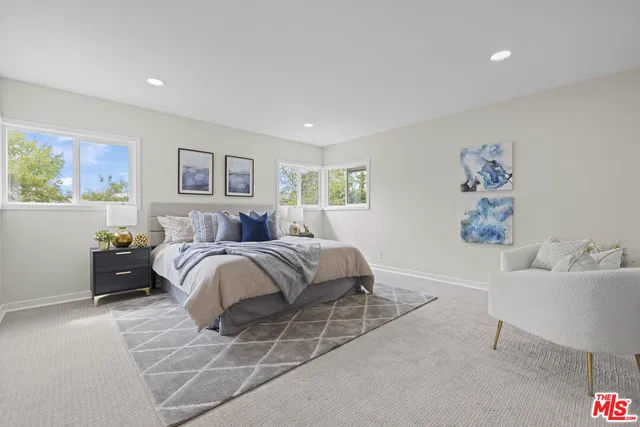 a spacious bedroom with a bed and a couch