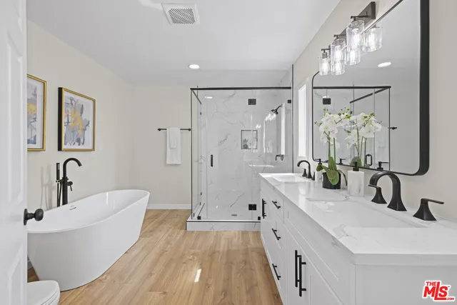 a bathroom with a double vanity sink mirror double and shower