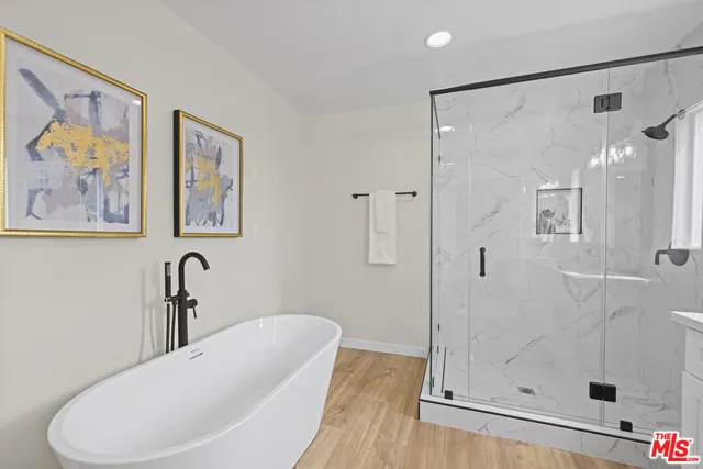 a bathroom with a bathtub and a shower