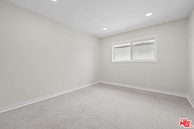 an empty room with a empty space and windows