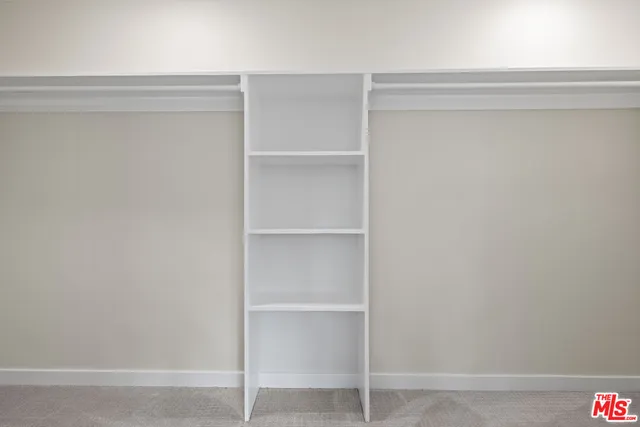 a living room with patio furniture and a potted plant