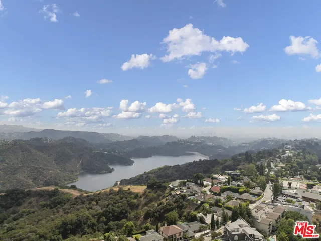 an aerial view of a house with a yard and lake view