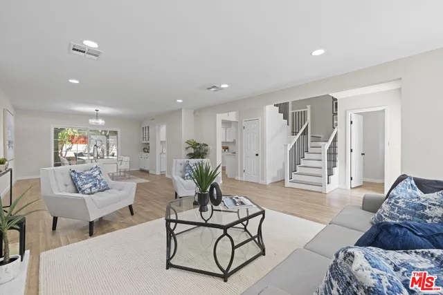 a living room with furniture and stairs