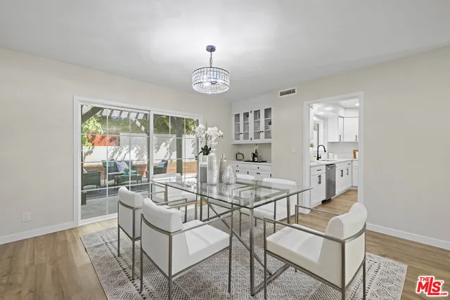 a view of a dining room with furniture wooden floor and a chandelier