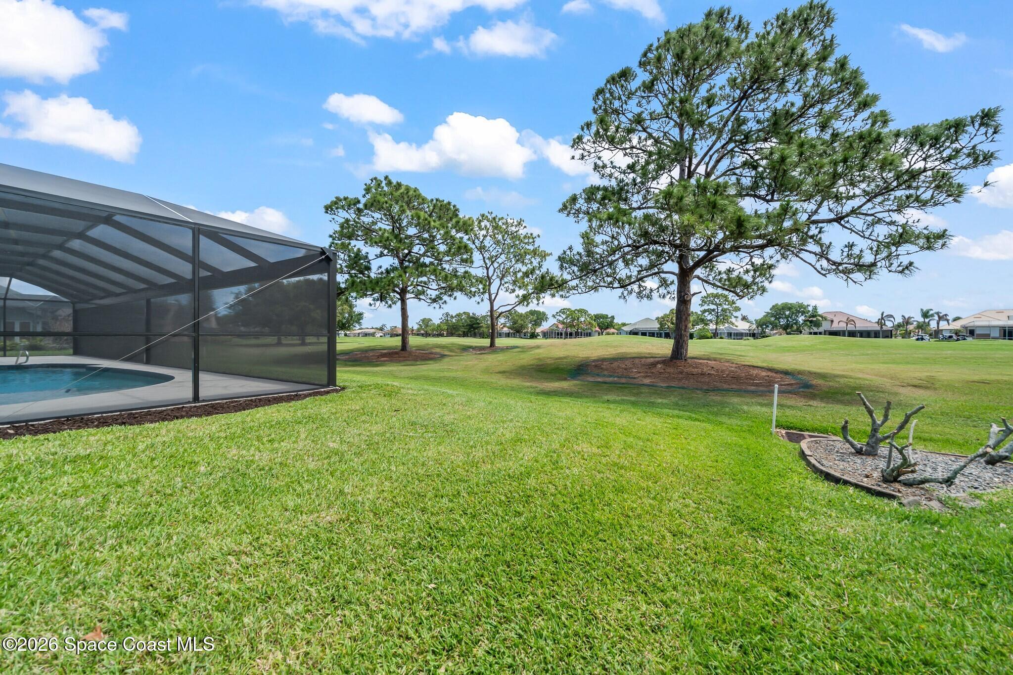 697 Spring Lake Drive Melbourne, FL 32940 - Photo 34 of 45 a view of a golf course with a lake