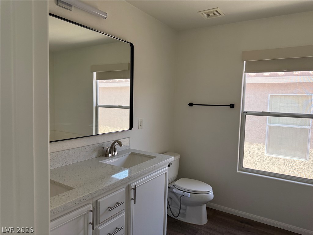 1141 Cathedral Ridge Street Henderson, NV 89052 - Photo 52 of 77 This bathroom features a contemporary vanity with a spacious mirror and elegant fixtures.