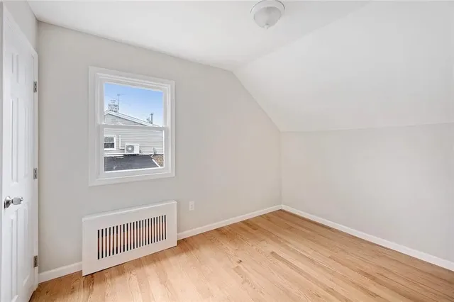a view of a room with wooden floor and windows