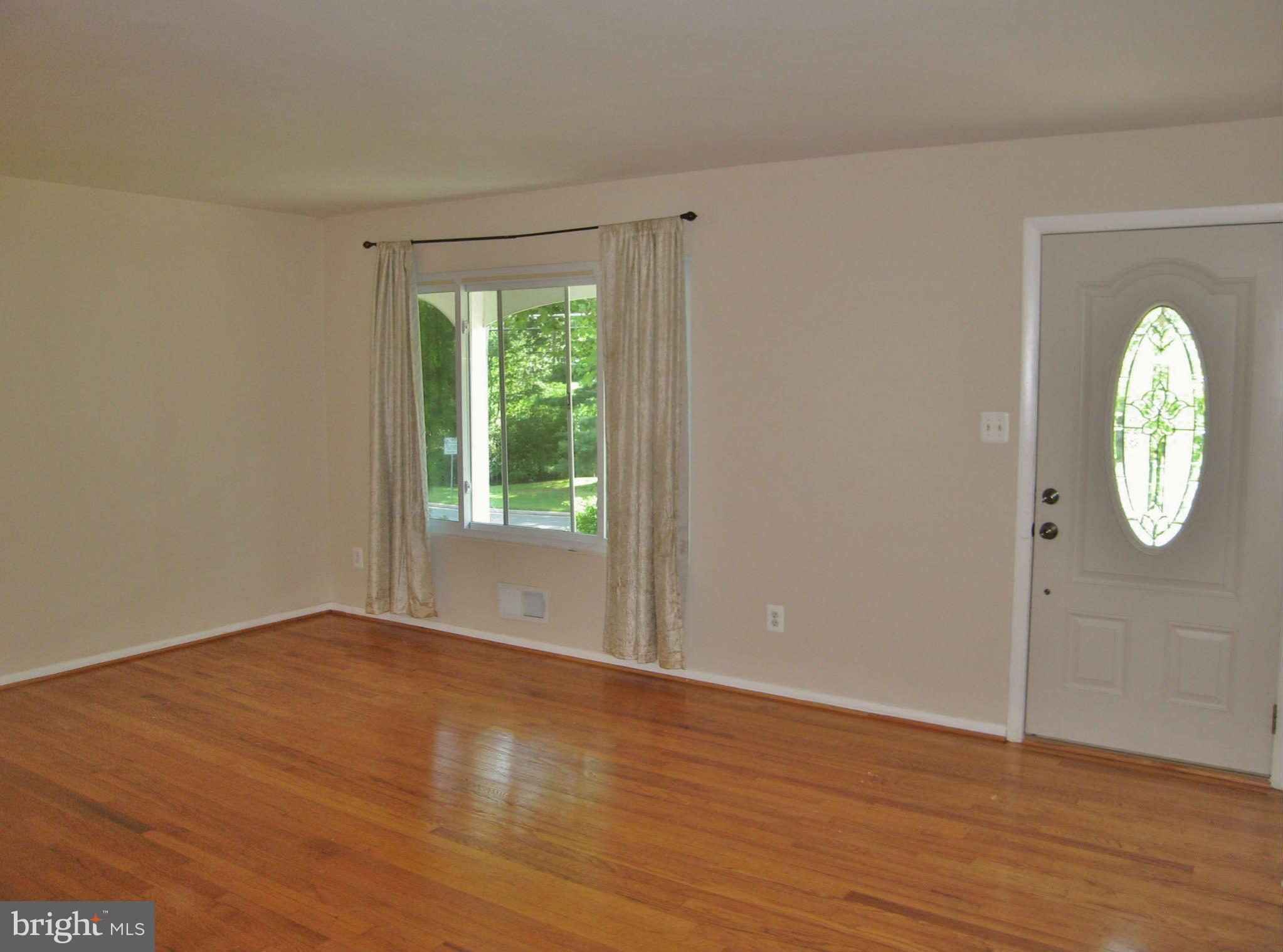 8113 Karl Road Alexandria, VA 22308 - Photo 2 of 15 wooden floor in an empty room with a window