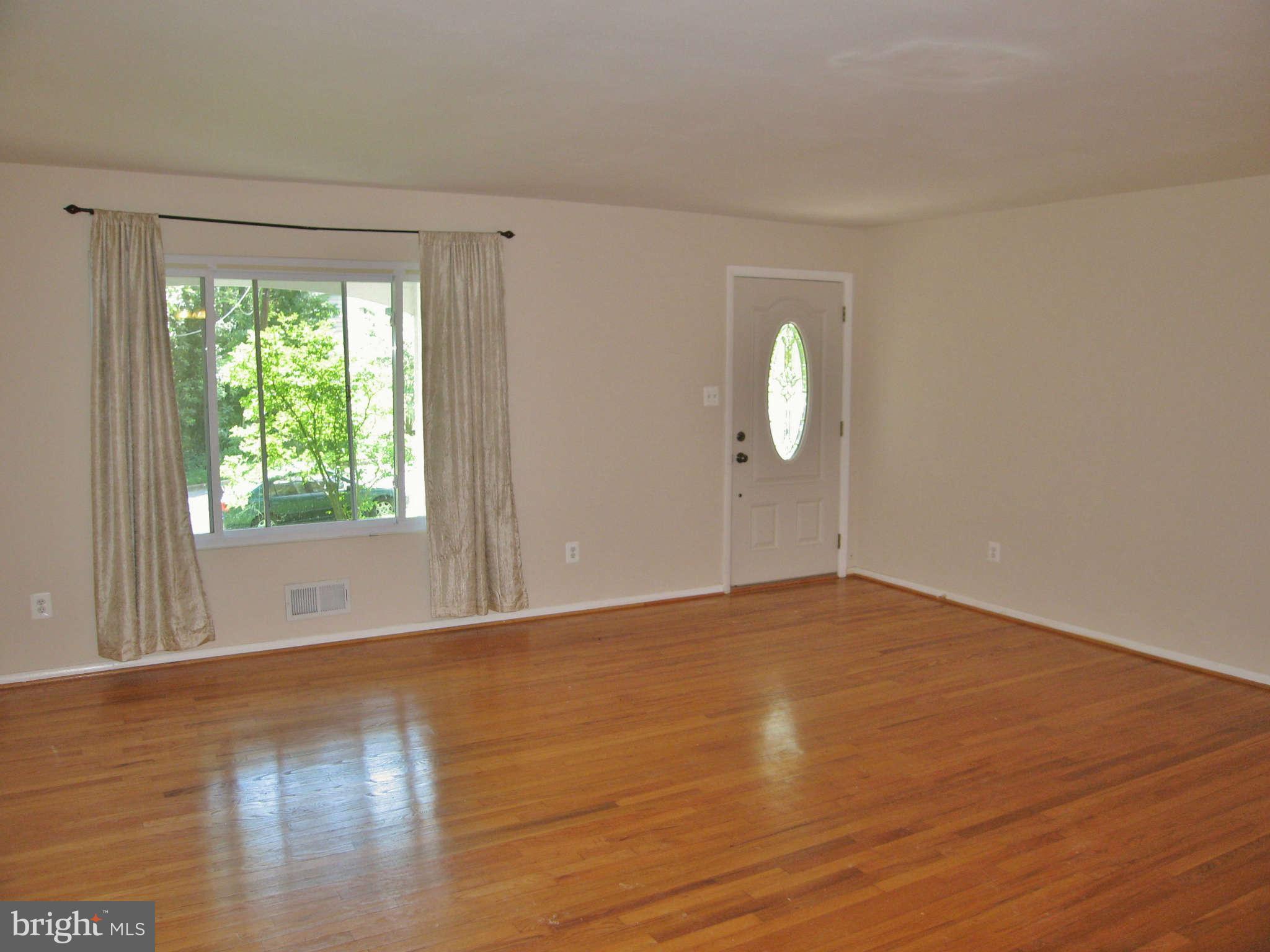 8113 Karl Road Alexandria, VA 22308 - Photo 3 of 15 a view of an empty room with wooden floor and a window