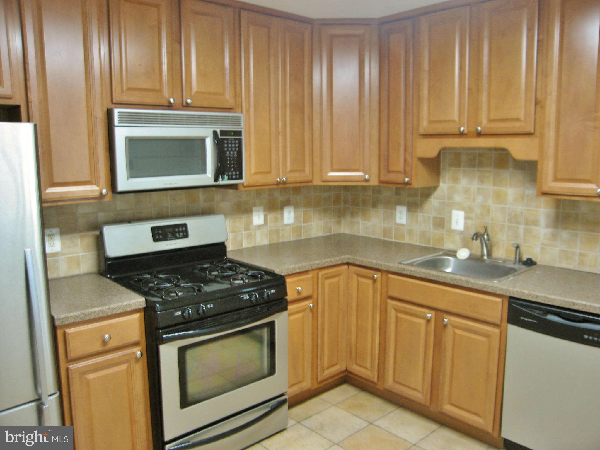 8113 Karl Road Alexandria, VA 22308 - Photo 4 of 15 a kitchen with granite countertop cabinets stainless steel appliances and a sink