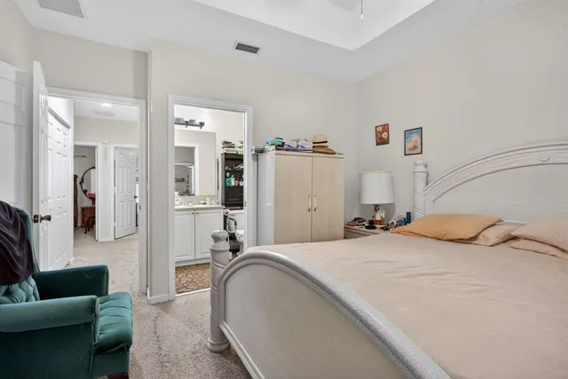 a spacious bedroom with a bed a couch and a couch