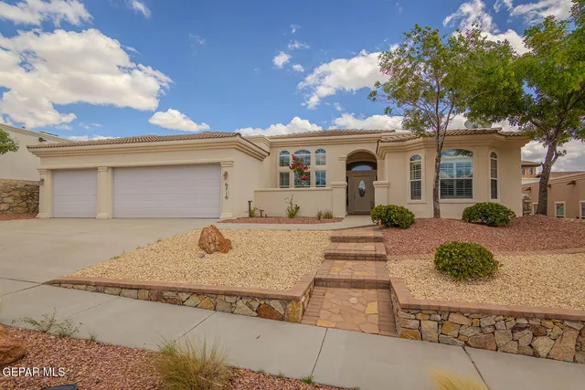 a front view of a house with garage