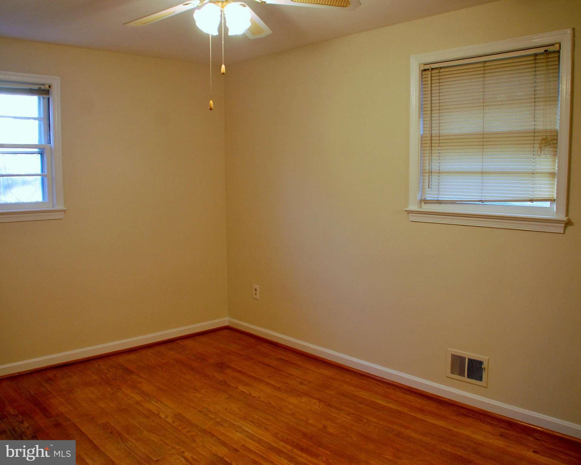 5508 Spruce Drive Clinton, MD 20735 - Photo 11 of 18 an empty room with a window and wooden floor
