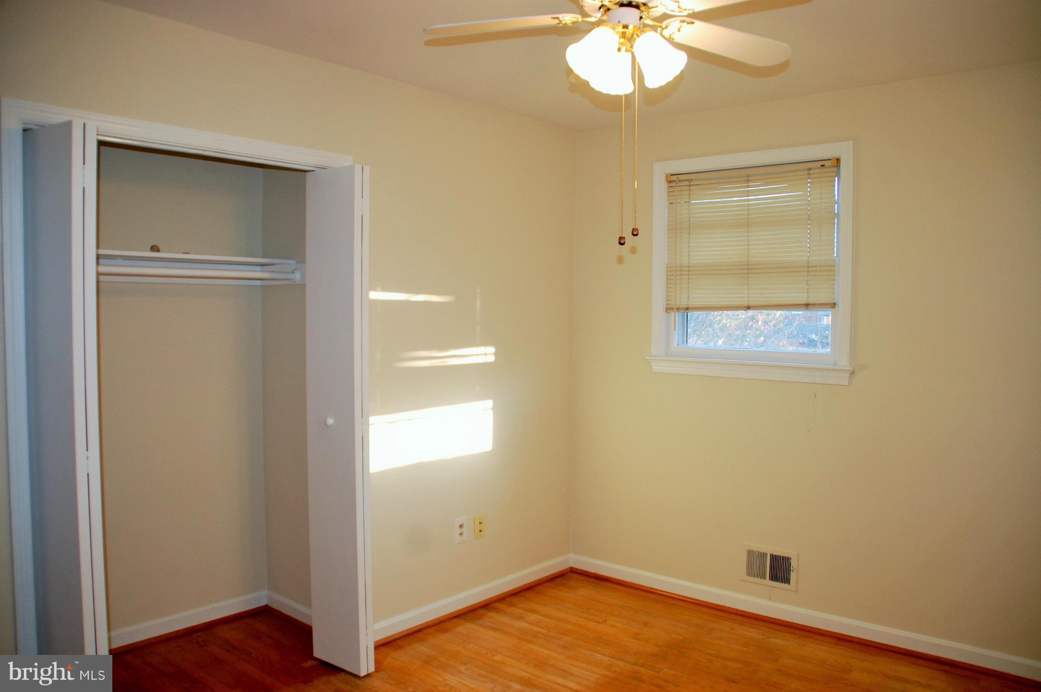 5508 Spruce Drive Clinton, MD 20735 - Photo 7 of 18 a view of an empty room with wooden floor and a window