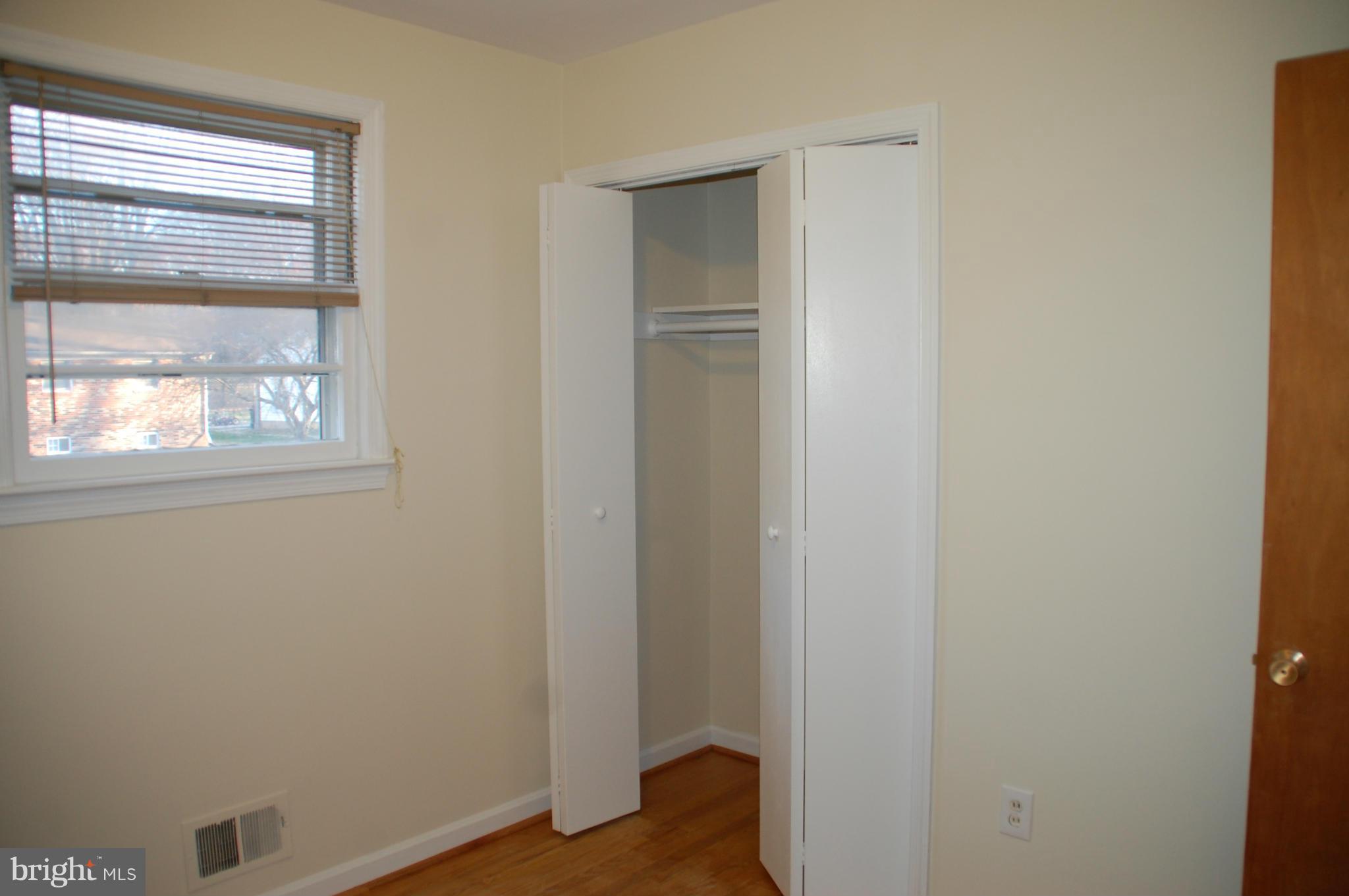 5508 Spruce Drive Clinton, MD 20735 - Photo 10 of 18 a view of an empty room with wooden floor and a window