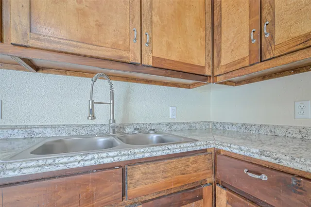a kitchen with stainless steel appliances granite countertop a sink a stove and cabinets