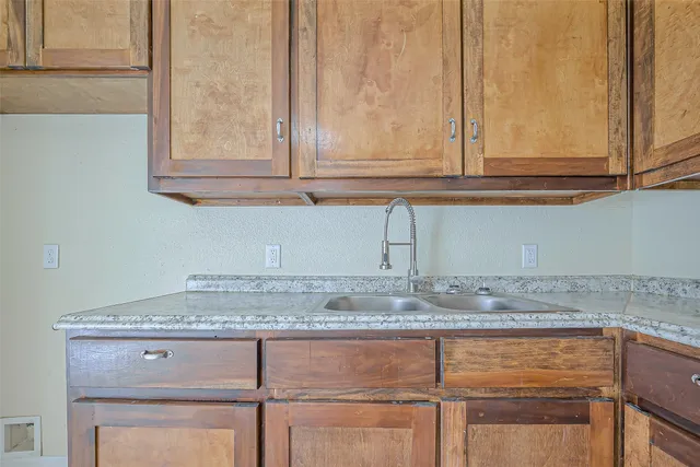 a kitchen with granite countertop cabinets and white countertops