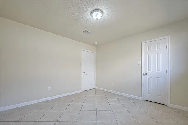 an empty room with white walls and windows