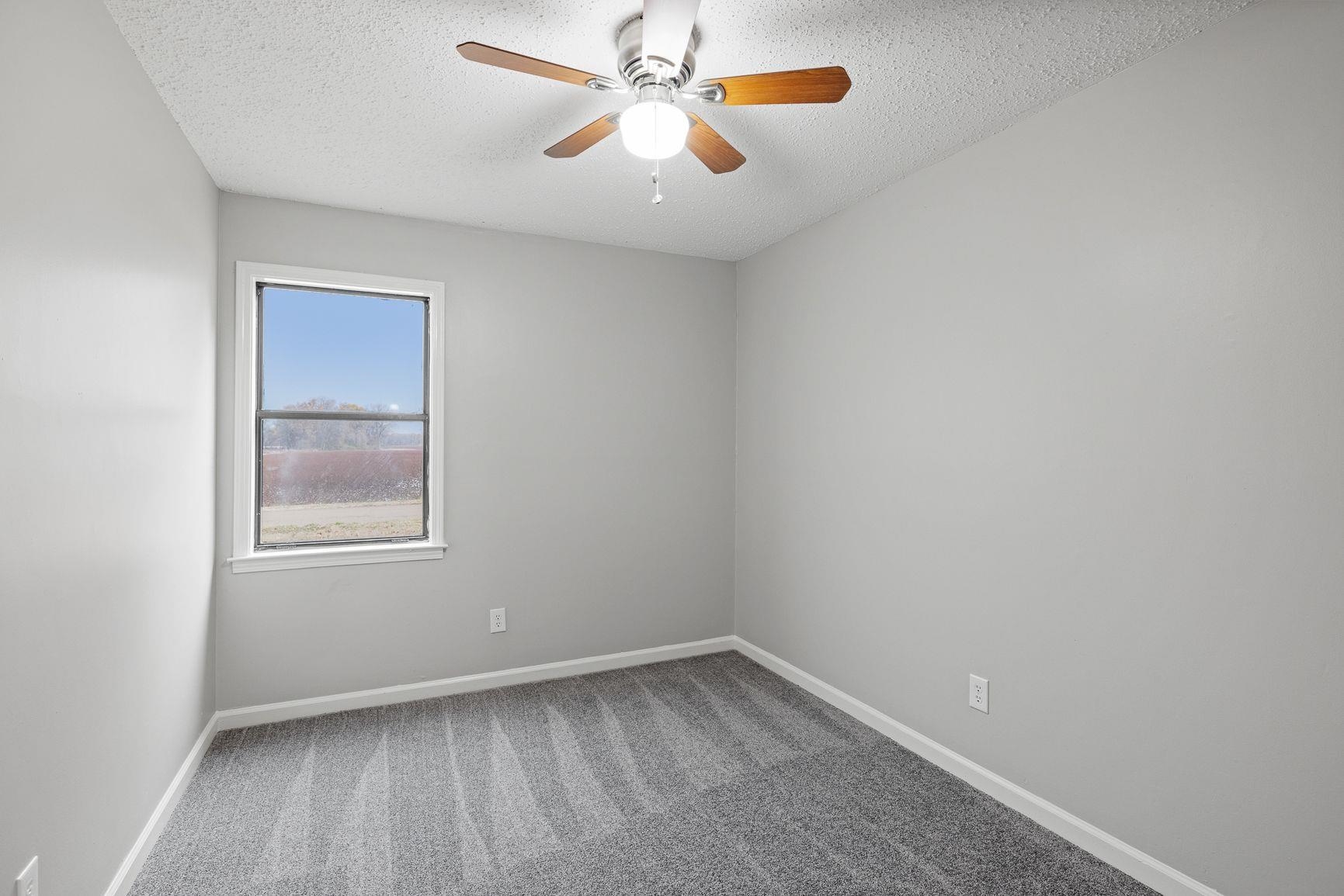267 Ervin Lane Covington, TN 38019 - Photo 13 of 23 an empty room with a window and a fan
