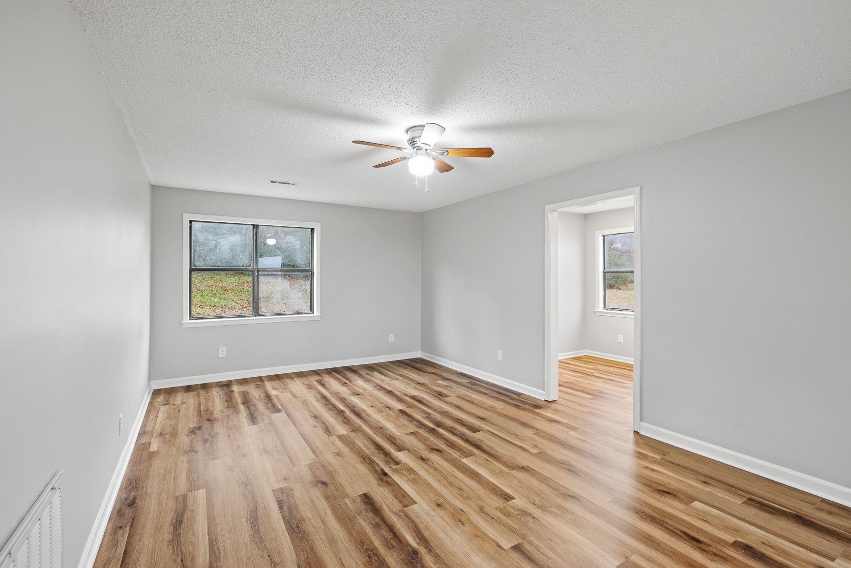 267 Ervin Lane Covington, TN 38019 - Photo 3 of 23 wooden floor in an empty room with a window