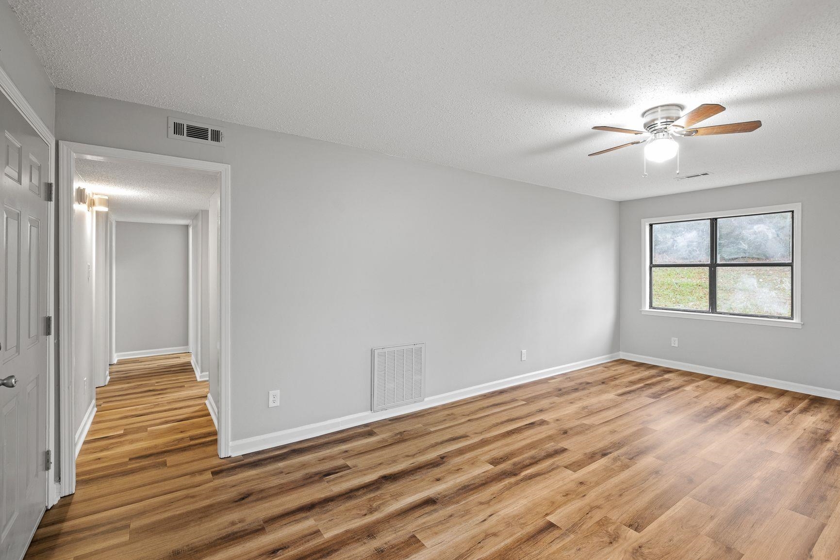 267 Ervin Lane Covington, TN 38019 - Photo 4 of 23 a view of empty room with wooden floor and fan