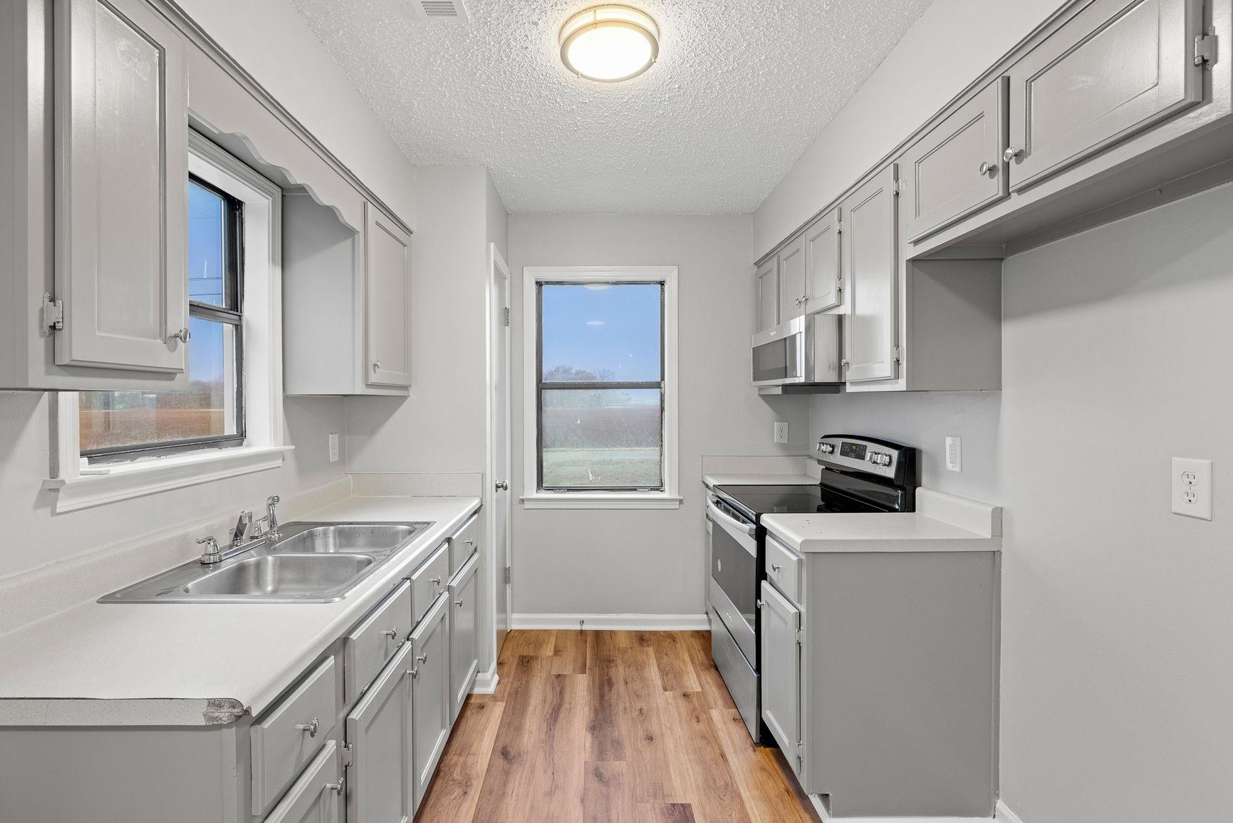 267 Ervin Lane Covington, TN 38019 - Photo 6 of 23 a kitchen with a sink stove and refrigerator