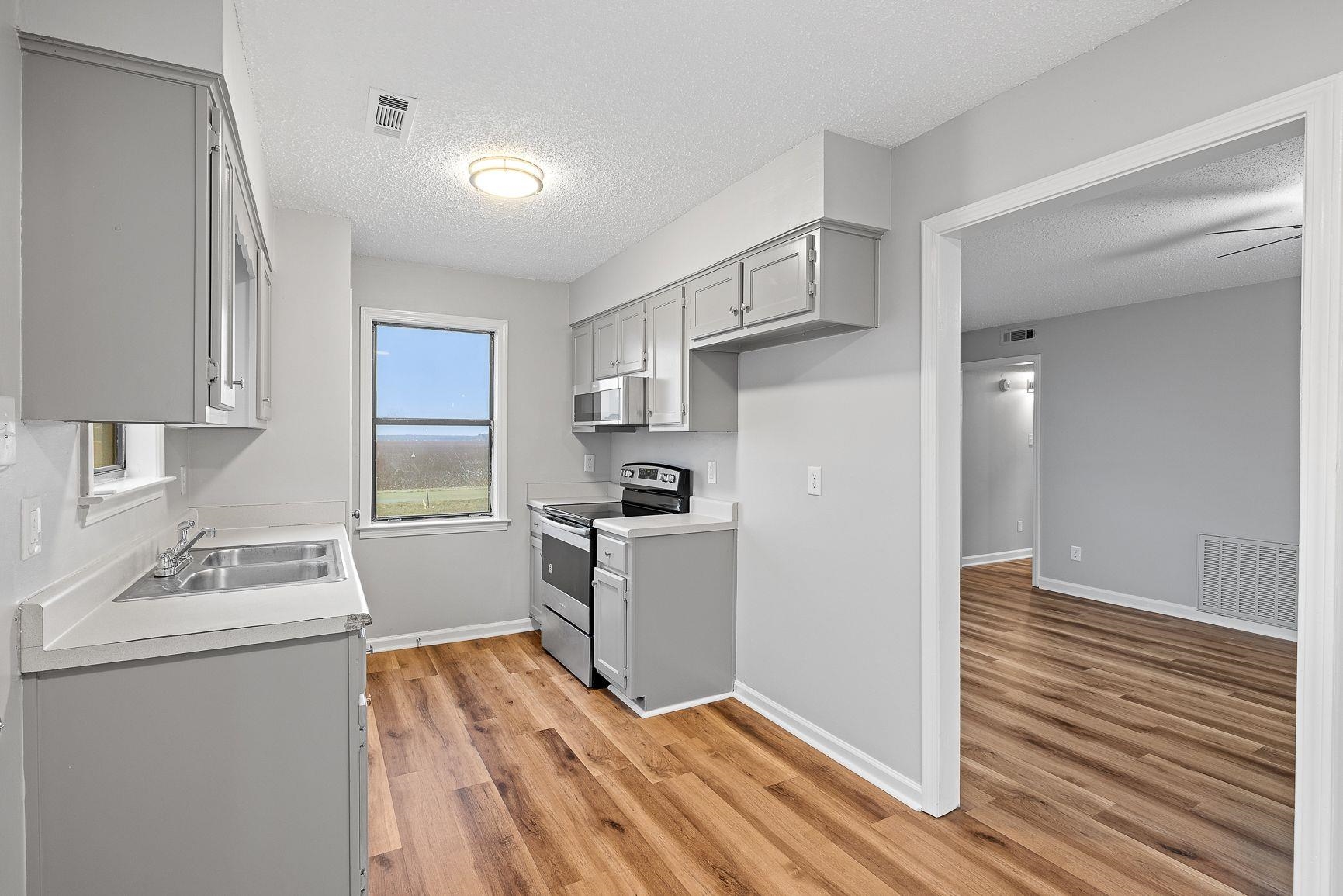267 Ervin Lane Covington, TN 38019 - Photo 7 of 23 a kitchen with a sink cabinets stainless steel appliances and a window