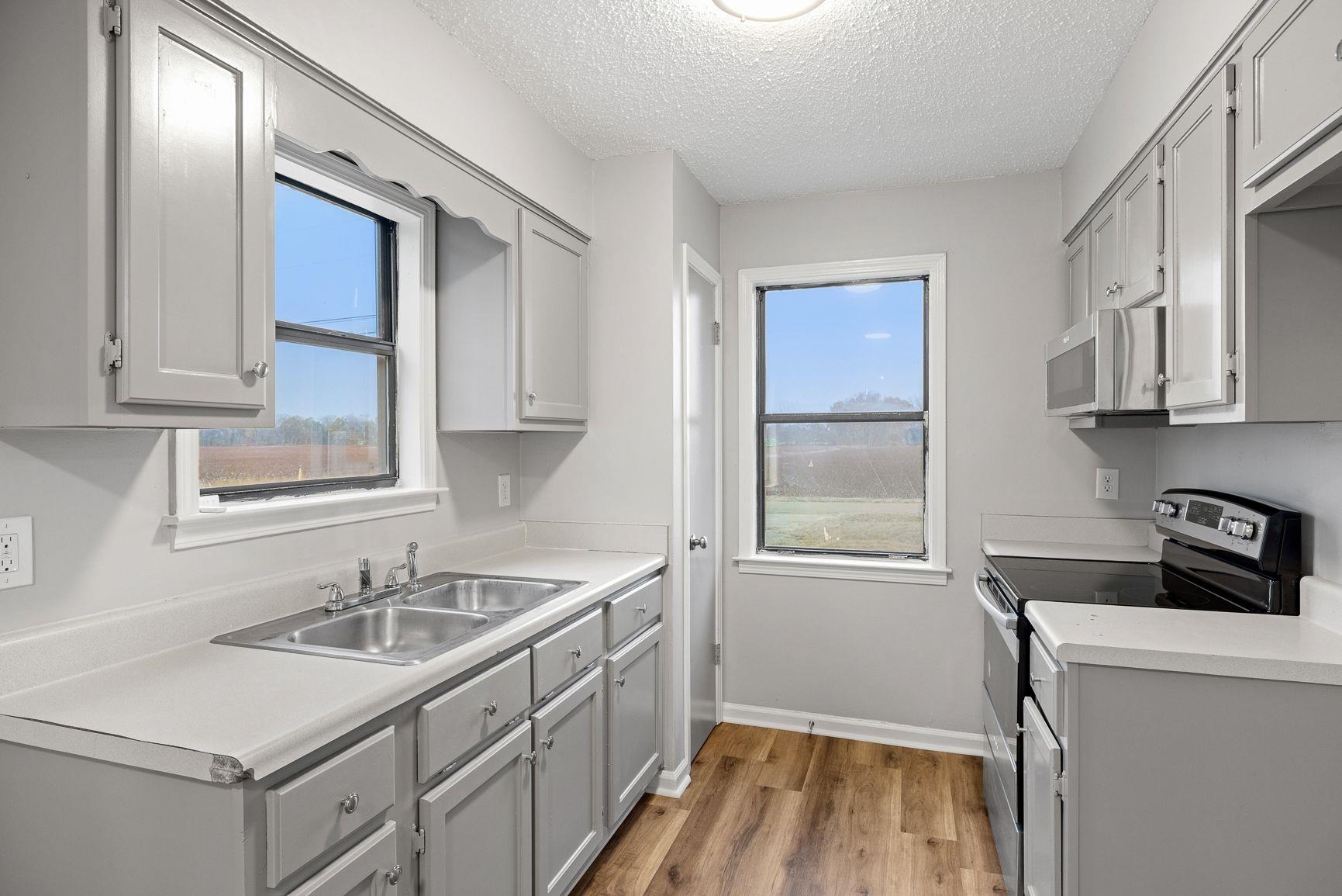 267 Ervin Lane Covington, TN 38019 - Photo 8 of 23 a kitchen that has a sink and a stove in it