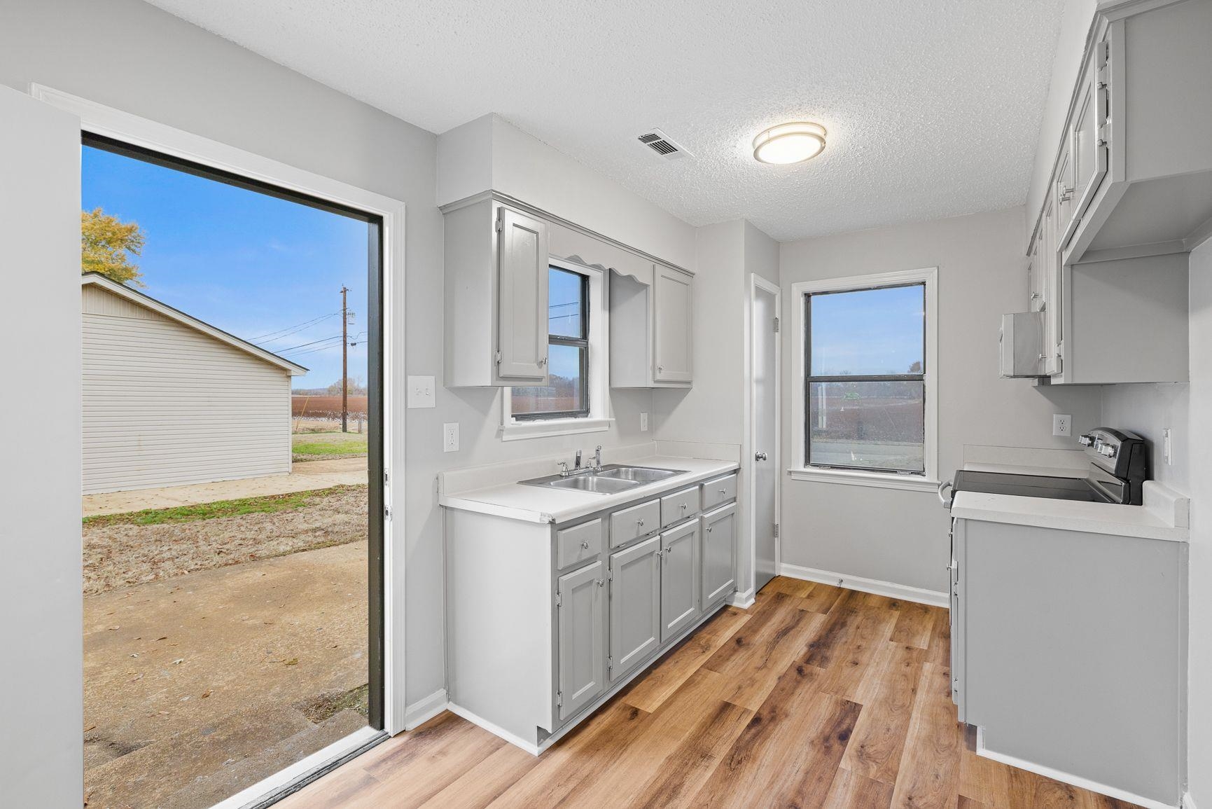 267 Ervin Lane Covington, TN 38019 - Photo 9 of 23 a kitchen with a sink stove and refrigerator