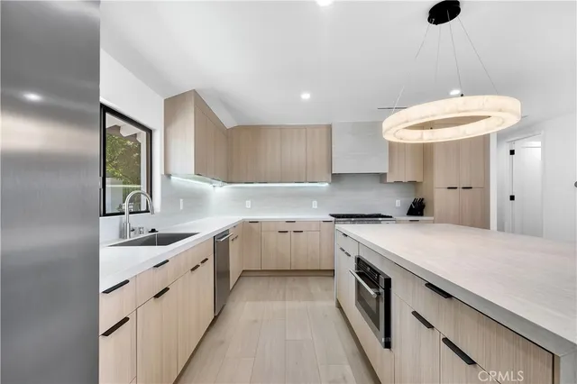 a kitchen with a sink stove and refrigerator