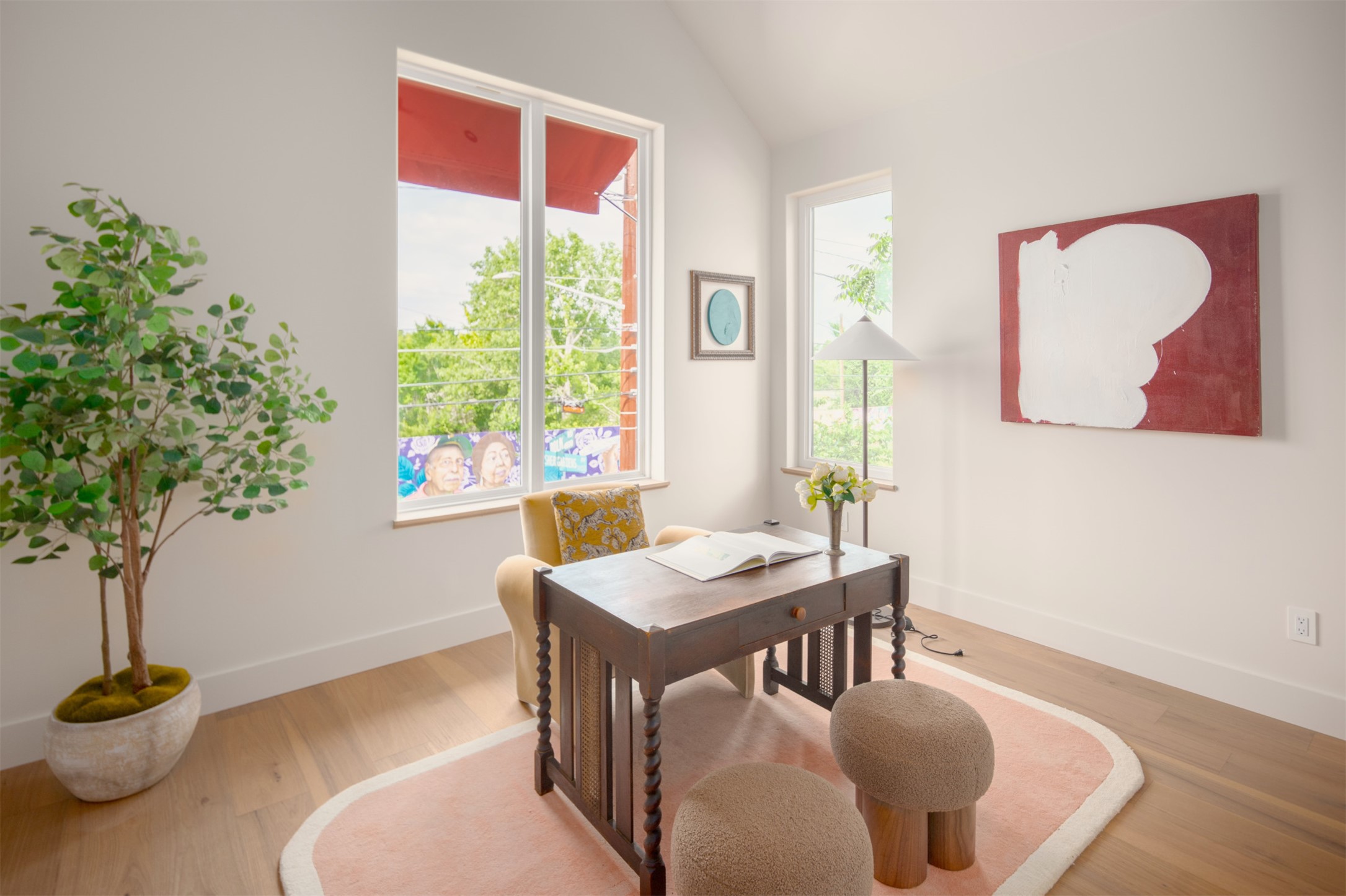 4713 Bolm Road Austin, TX 78702 - Photo 29 of 40 Bright room featuring tall windows, vaulted ceiling, light wood-finish flooring, and white baseboards