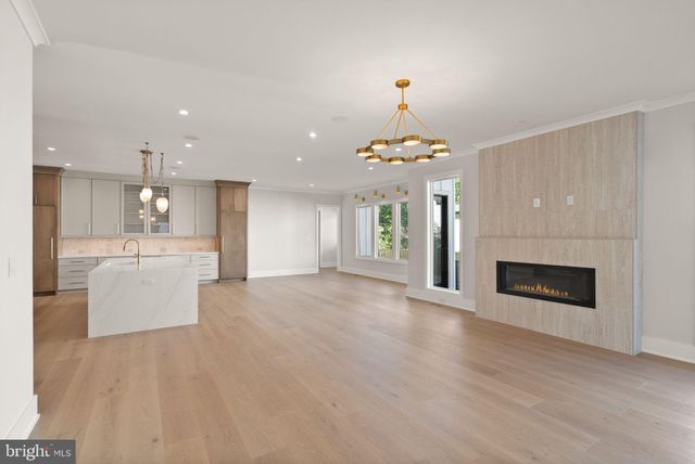 a view of a kitchen with a sink a fireplace and a window