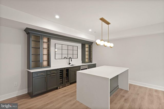 a kitchen with a sink and chandelier