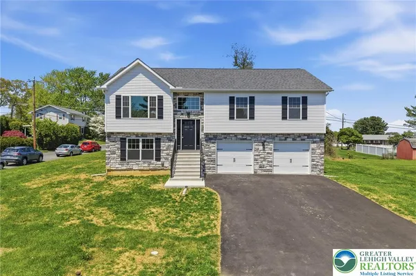 a front view of a house with a yard