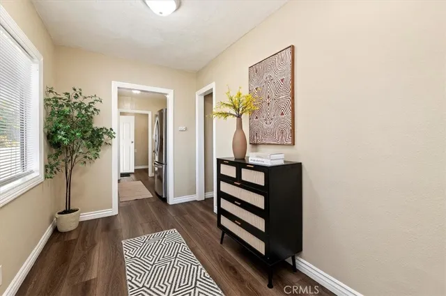 a view of a hallway with wooden floor and front door