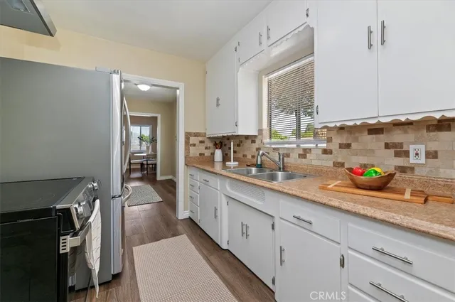 a kitchen with stainless steel appliances a sink stove and cabinets