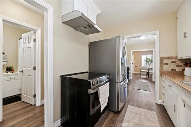 a kitchen with a refrigerator and a stove