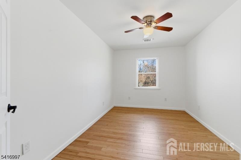 2 Rossi Drive Clinton, NJ 08809 - Photo 29 of 73 an empty room with wooden floor and ceiling fan