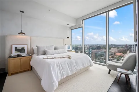 a bedroom with a bed and large window