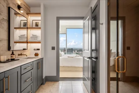 a bathroom with a double vanity sink a mirror and shower