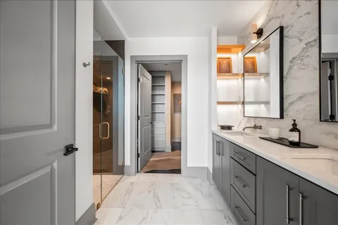 a bathroom with a double vanity sink and a mirror