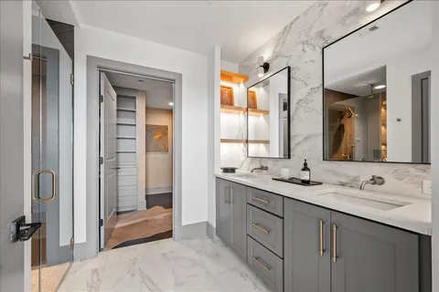a bathroom with a granite countertop sink mirror and double