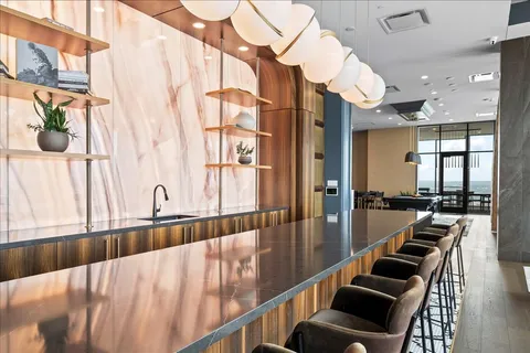 a hallway with wooden floor and furniture