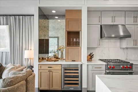 a kitchen with kitchen island granite countertop a sink and a stove