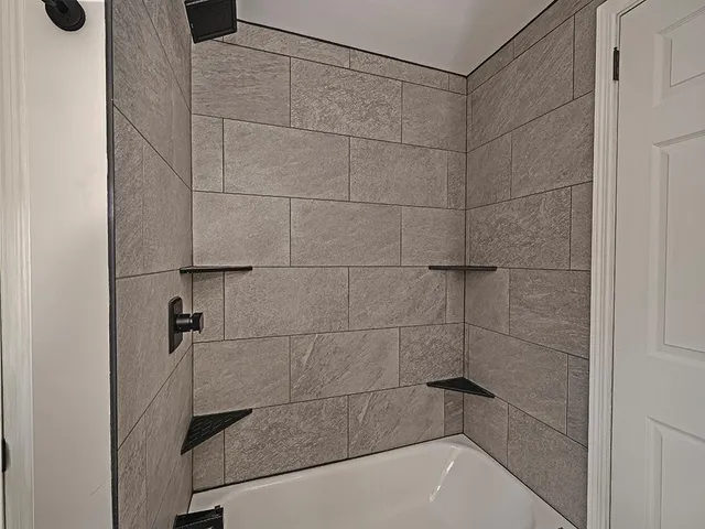 a bathroom with a shower and a bathtub