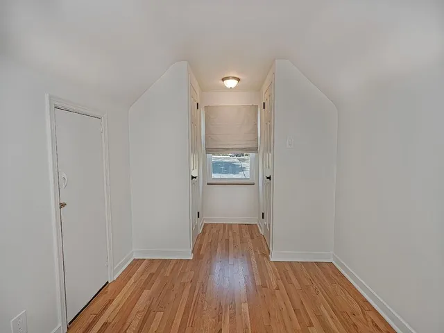 a view of a room with wooden floor